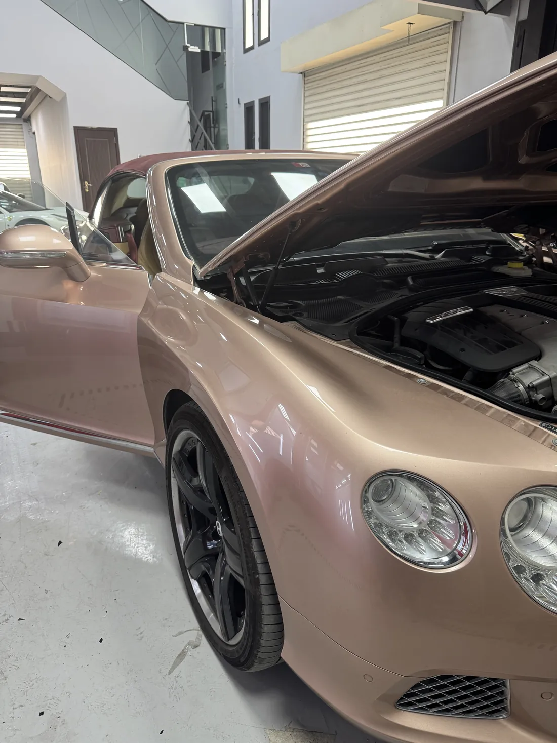 Bentley Continental mid-respray in pink at the FoilX body shop