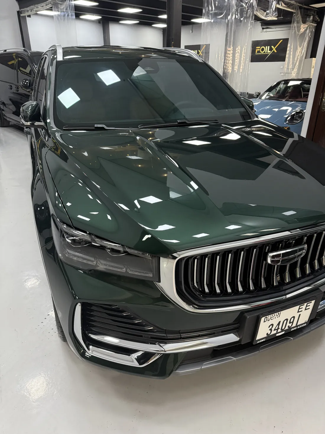 Green Geely SUV protected with paint protection film in Dubai