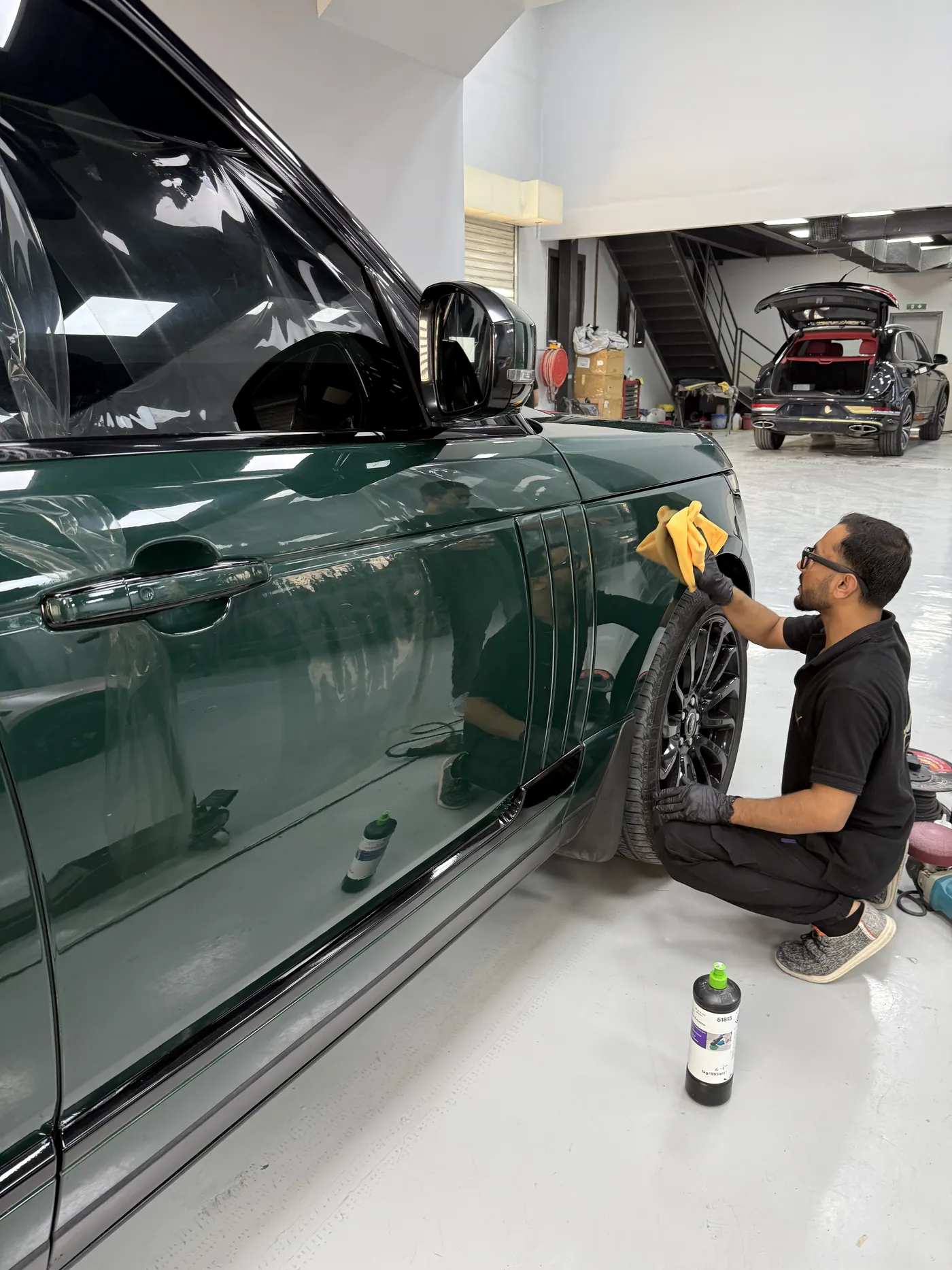 FoilX installer applying green wrap film to a Range Rover door